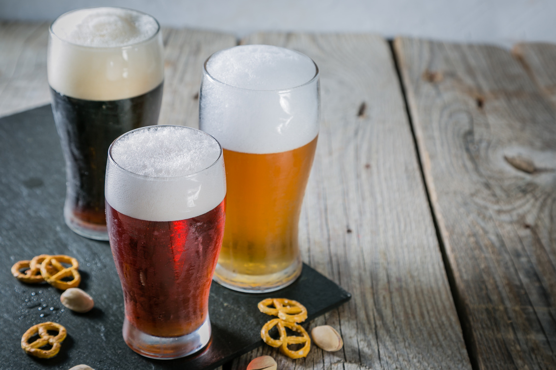 Different Types of Beer on Rustic Wood Background